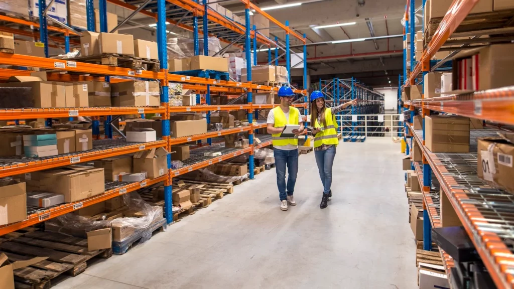 2 people walking in a warehouse