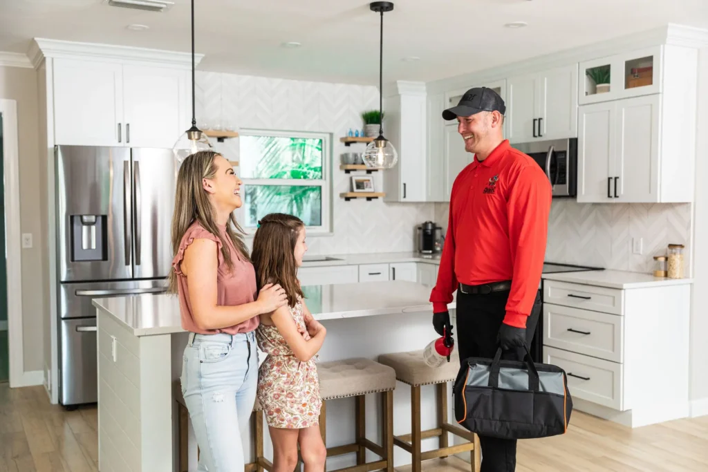 All U Need Pest Control Technician Talking with Family of the Residence