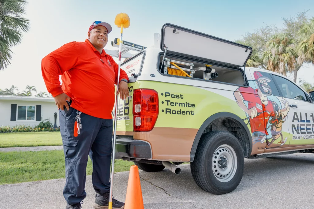 All u need pest control technician next to branded vehicle