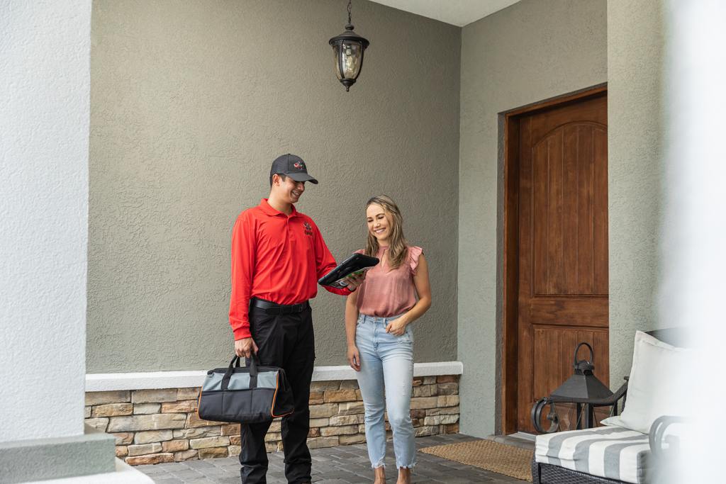 All "U" Need Pest Control Technician Discussing Options With A Customer