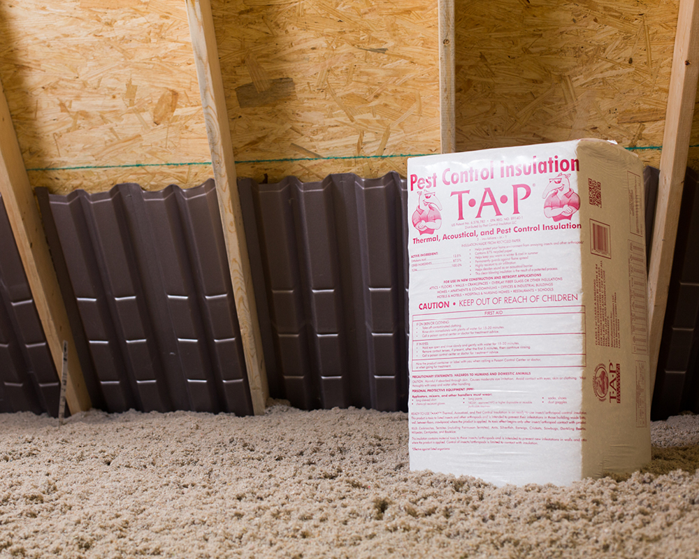 A package of TAP insulation sitting in the attic surrounded by blown-in TAP insulation
